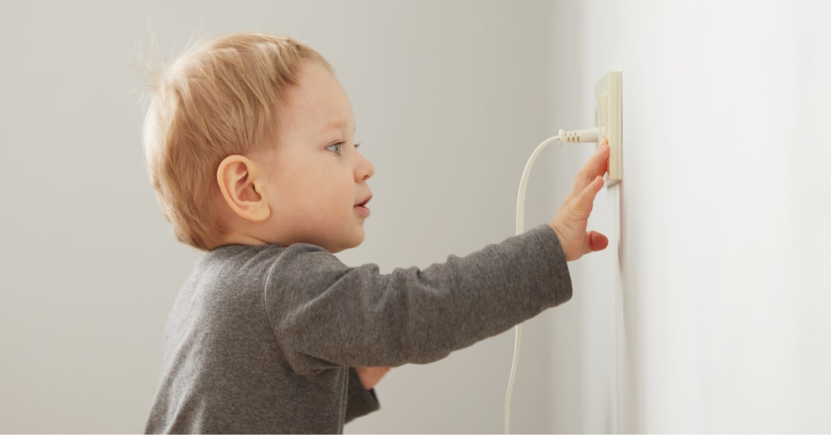 Child looking at outlet