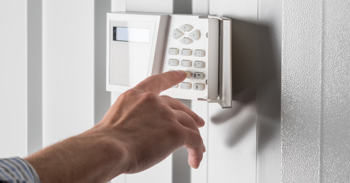 Pressing numbers on an alarm system keypad.