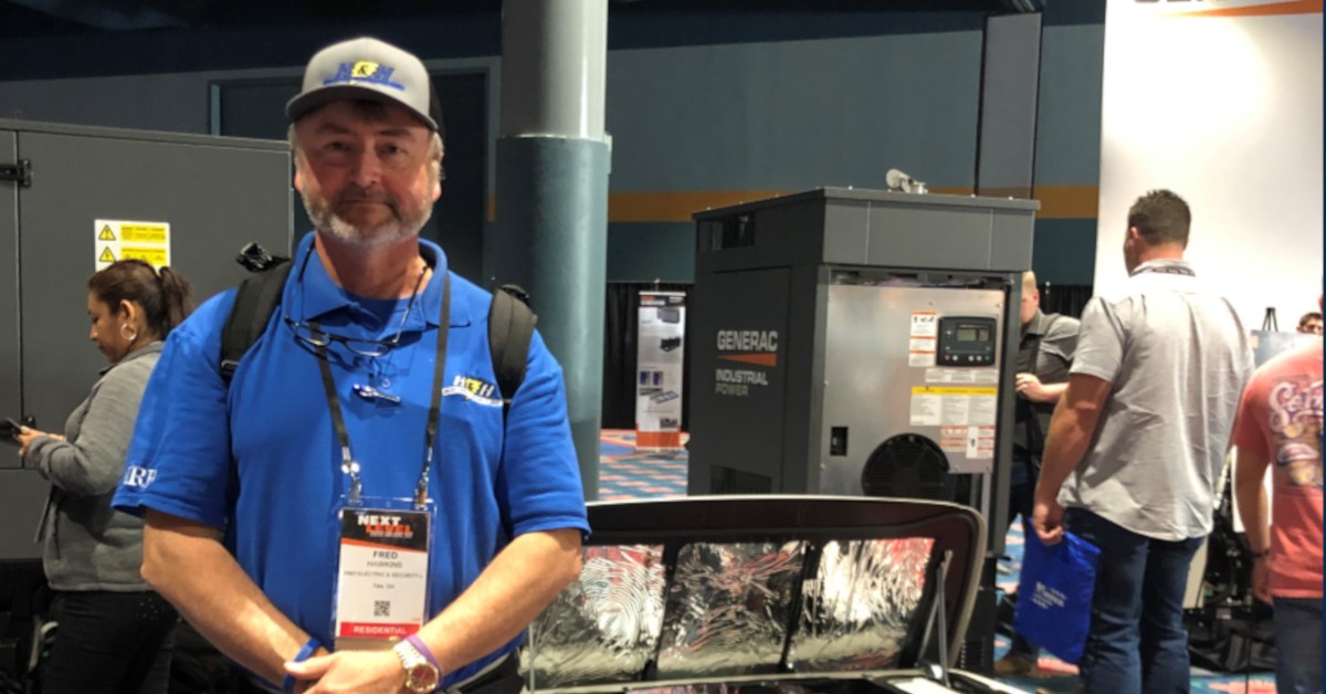 Fred stands in front of sample generator equipment at the annual Generac conference.