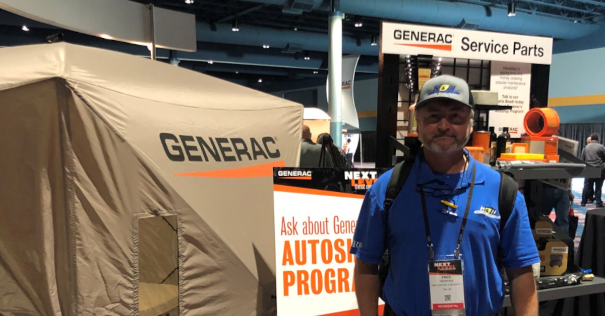 Fred stands in front of a Generac tent.
