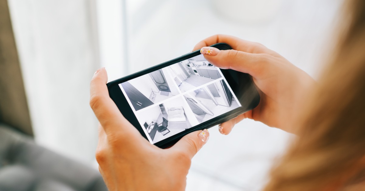 A woman views her security camera feeds from her phone.